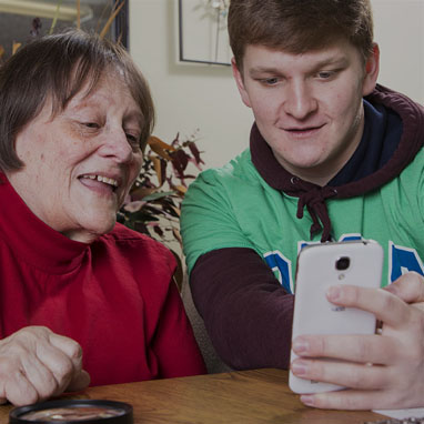 Enhanced Living caregiver and woman on cell phone
